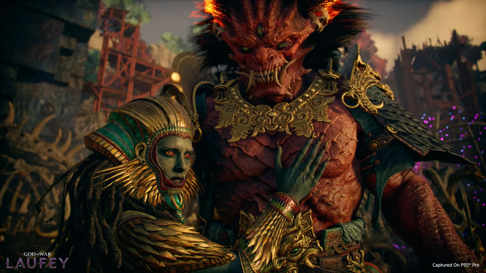 Faye in an ornate golden headdress embracing a massive red horned giant with flaming hair in dark ruins